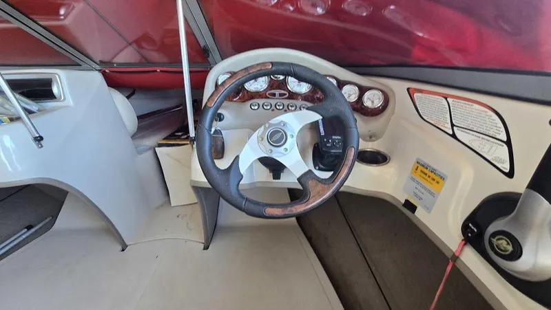 Slide: The Image of 2014 Tahoe Q5i boat dashboard with steering wheel and gauges. - 15