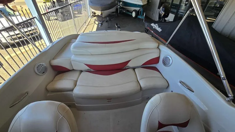 Slide: The Image of 2014 Tahoe Q5i boat interior with white and red seating, featuring built-in speakers. - 17