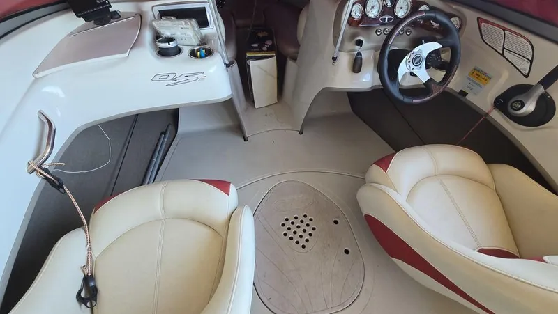 Slide: The Image of Interior of a 2014 Tahoe Q5i boat with steering wheel and seating. - 3