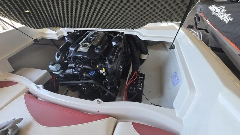 Slide: The Image of 2014 Tahoe Q5i boat engine compartment with open hatch, showcasing engine and battery. - 5