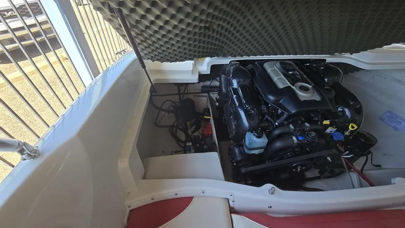 Slide: The Image of 2014 Tahoe Q5i boat engine compartment with open hatch, showcasing engine details. - 8