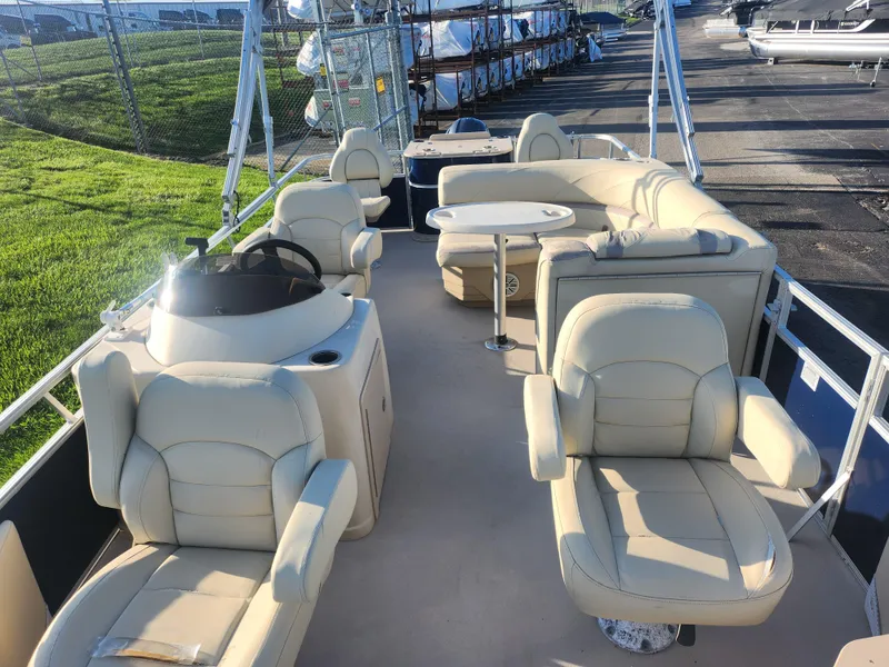 Slide: The Image of 2018 SunChaser Geneva Cruise 22 DLX 4.0 Fish pontoon boat with beige seating and steering console. - 11