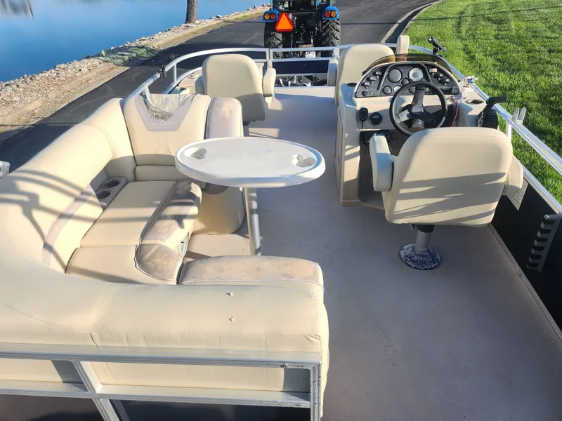 Slide: The Image of 2018 SunChaser Geneva Cruise 22 DLX 4.0 Fish pontoon boat with beige seating and steering console. - 20