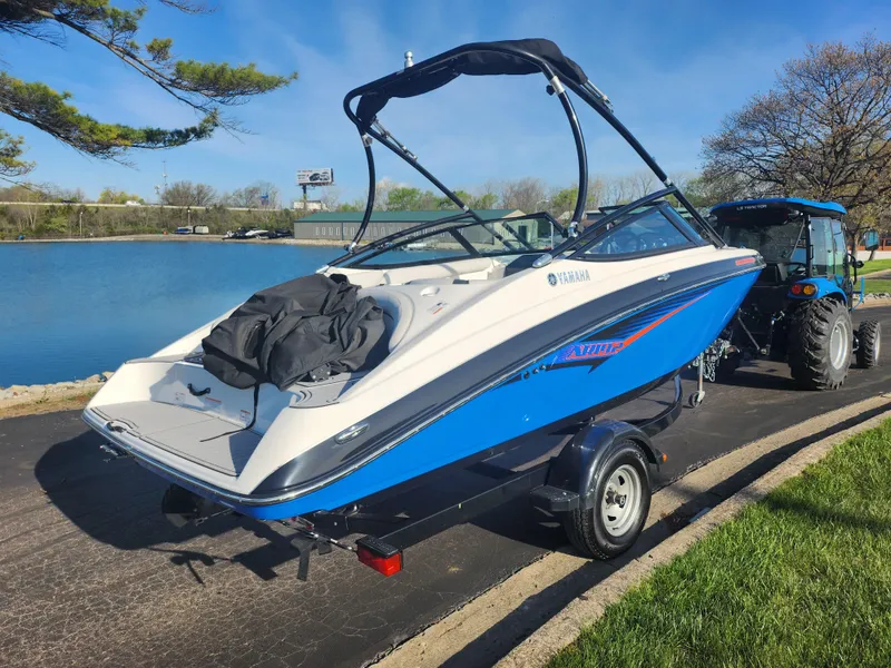 Slide: The Image of 2014 Yamaha Boats AR192 on trailer by a lake, ready for water adventure. - 1