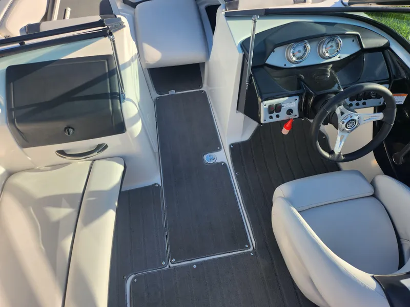 Slide: The Image of 2014 Yamaha Boats AR192 interior with steering wheel and dashboard, featuring sleek design and seating. - 11