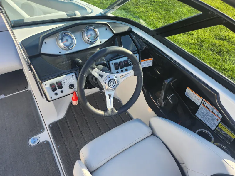 Slide: The Image of 2014 Yamaha Boats AR192 dashboard and steering wheel, featuring modern controls and gauges. - 12