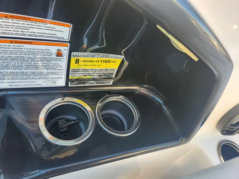 Slide: The Image of Cup holders and capacity warning on 2014 Yamaha Boats AR192 dashboard. - 13