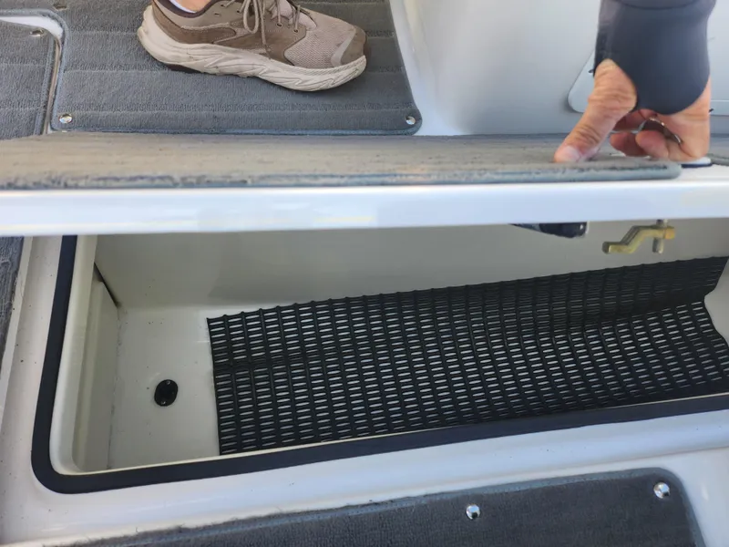 Slide: The Image of 2014 Yamaha AR192 boat storage compartment with open lid and visible interior. - 14