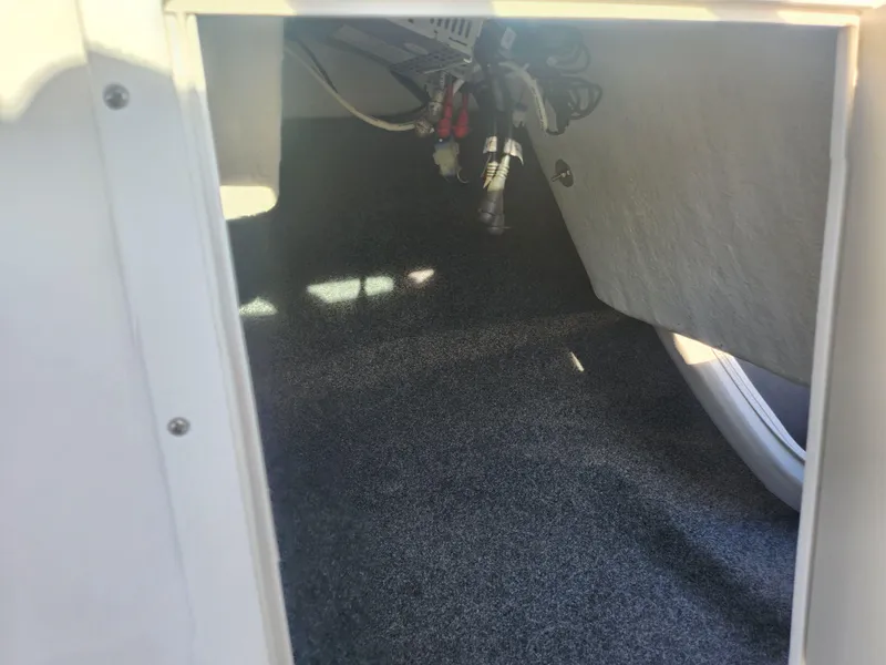 Slide: The Image of Interior storage compartment of 2014 Yamaha AR192 boat, showing wiring and carpeted floor. - 15