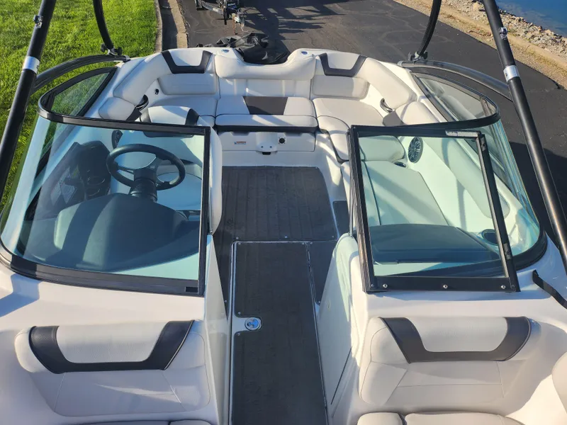 Slide: The Image of 2014 Yamaha Boats AR192 interior with seating and steering wheel, docked on a sunny day. - 18