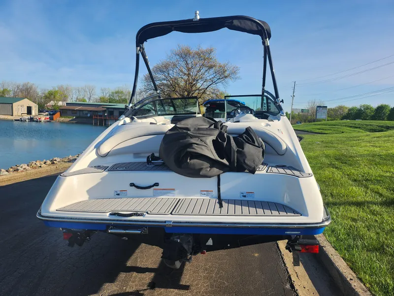 Slide: The Image of 2014 Yamaha Boats AR192 on trailer by lakeside, sunny day, green grass, clear sky. - 2