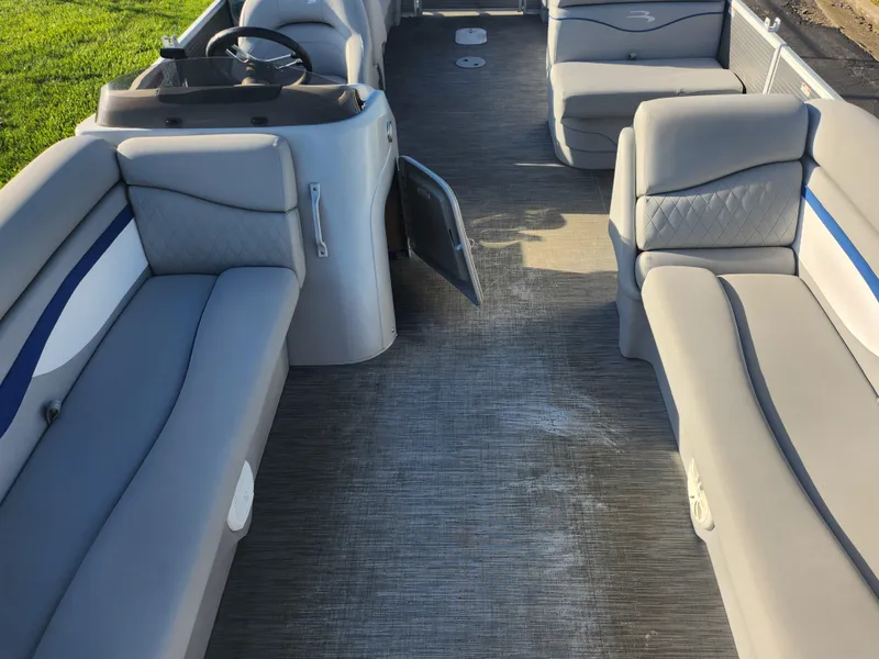 Slide: The Image of 2022 Bennington S 22 L-Bench pontoon boat interior with gray seating and steering console. - 14