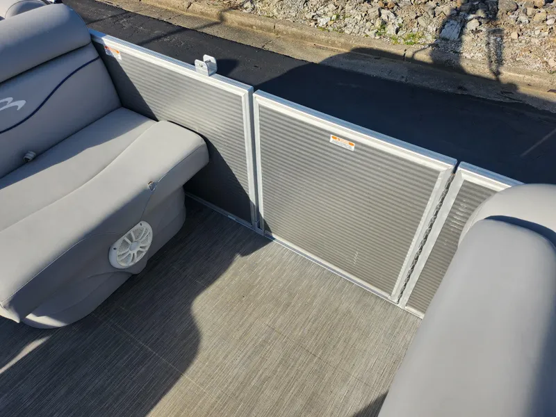 Slide: The Image of 2022 Bennington S 22 L-Bench boat interior with gray seating and speaker. - 17