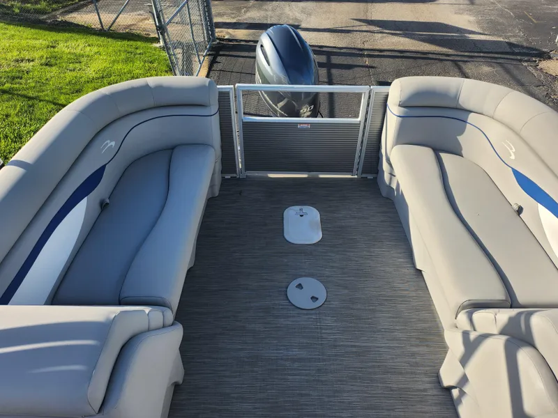 Slide: The Image of 2022 Bennington S 22 L-Bench pontoon boat interior with gray seating and flooring. - 21