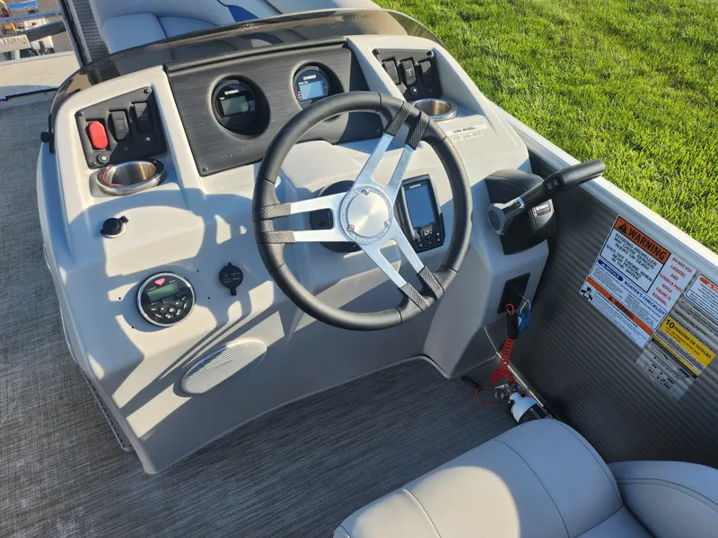 Slide: The Image of 2022 Bennington S 22 L-Bench boat dashboard with steering wheel and controls. - 25