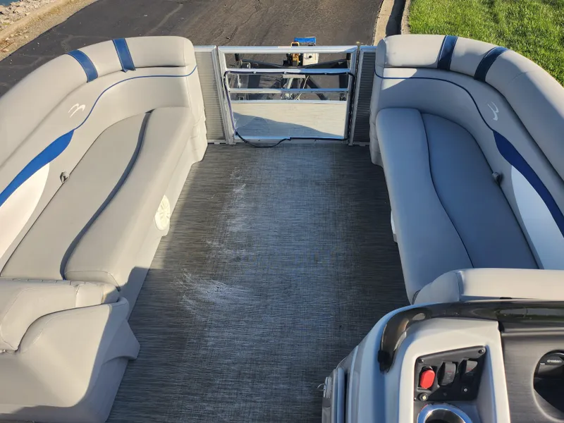 Slide: The Image of 2022 Bennington S 22 L-Bench pontoon boat interior with gray seating and control panel. - 27