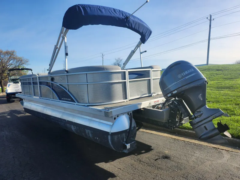 Slide: The Image of 2022 Bennington S 22 L-Bench pontoon boat with Yamaha outboard motor on a sunny day. - 3
