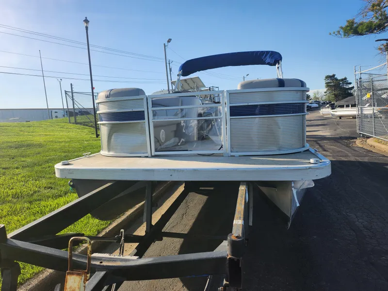 Slide: The Image of 2022 Bennington S 22 L-Bench pontoon boat on trailer, sunny day, outdoor setting. - 6