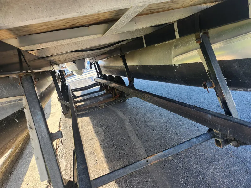 Slide: The Image of Underneath view of a 2022 Bennington S 22 L-Bench pontoon boat on a trailer. - 7