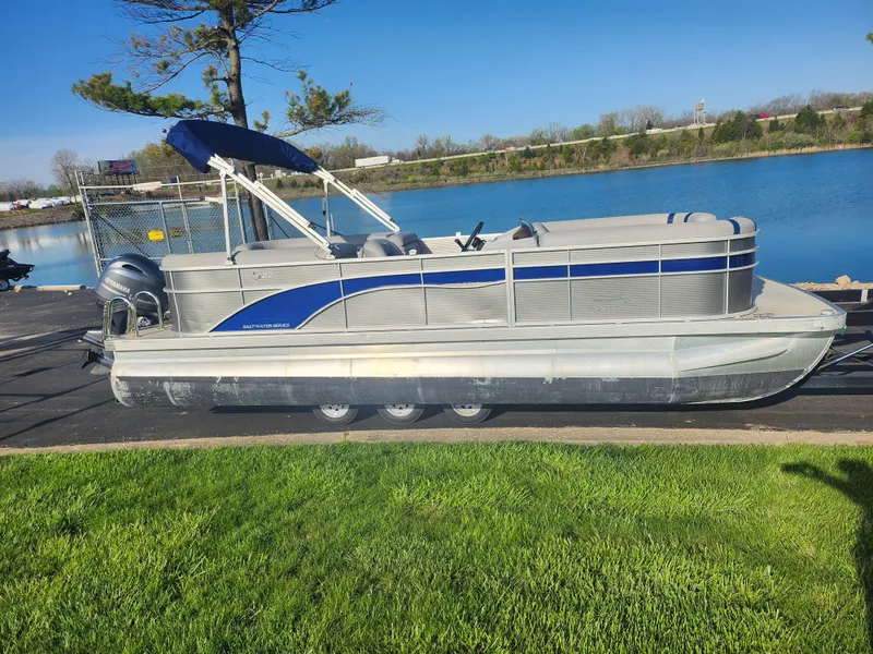 Slide: The Image of 2022 Bennington S 22 L-Bench pontoon boat by a serene lake. - 9