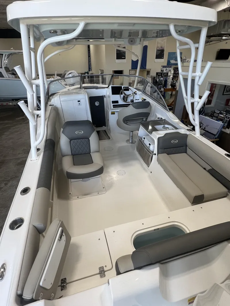 Slide: The Image of 2025 Key West Dual Console 239DFS boat interior with seating and helm station. - 7