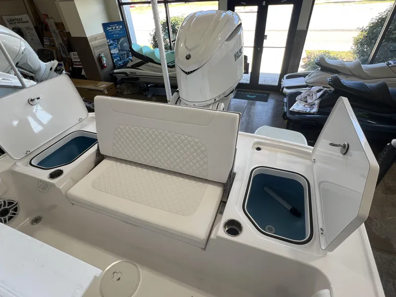 Slide: The Image of 2024 Caymas HB 26 boat interior with seating and storage compartments. - 4