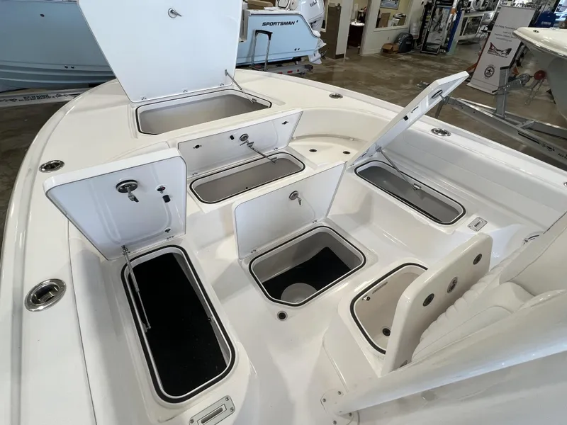 Slide: The Image of 2024 Caymas HB 26 boat with open storage compartments in showroom. - 5
