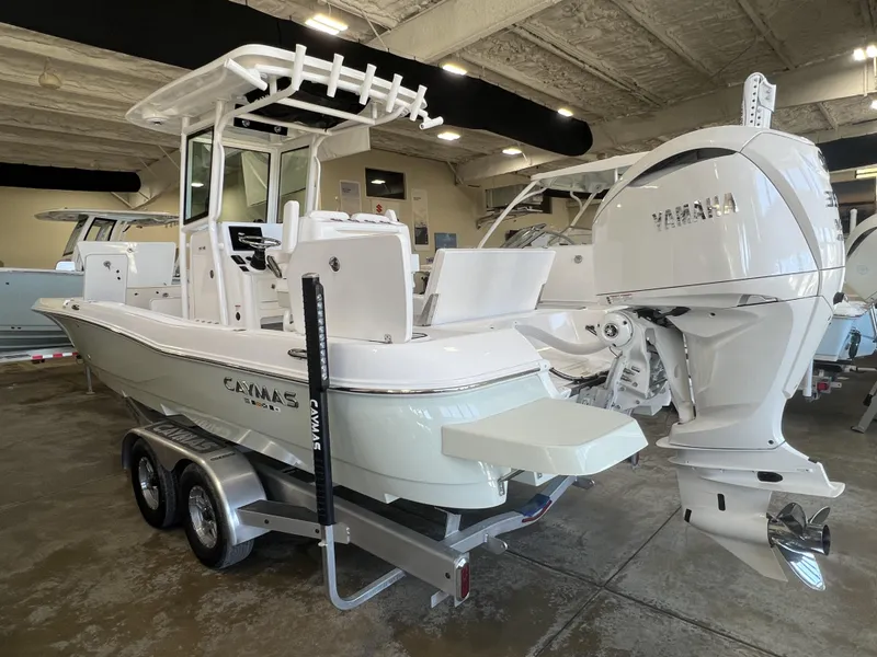 Slide: The Image of 2024 Caymas HB 26 boat with Yamaha engine on a trailer in a showroom. - 6
