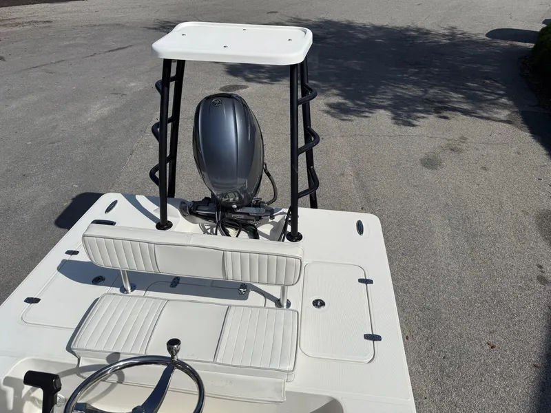 Slide: The Image of 2015 Spyder Boats FX17 FLICKER with outboard motor and seating, parked on pavement. - 10