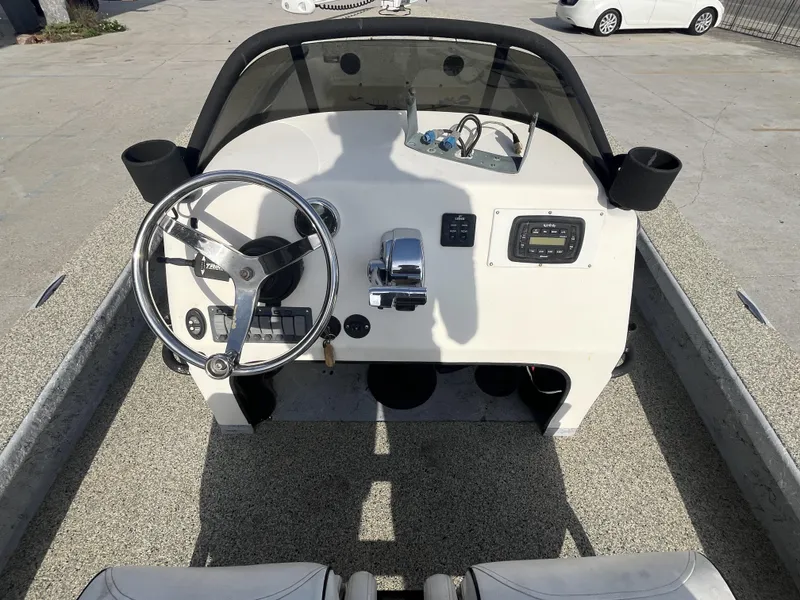 Slide: The Image of 2013 Haynie 24 HO boat dashboard with steering wheel and controls. - 12