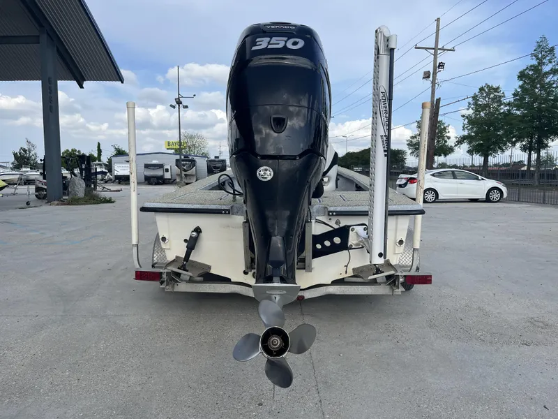 Slide: The Image of 2013 Haynie 24 HO boat with 350 horsepower engine, parked on a trailer. - 4