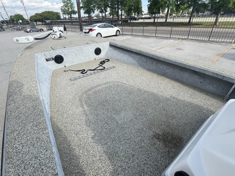 Slide: The Image of 2013 Haynie 24 HO boat deck with textured surface, parked in a lot. - 6