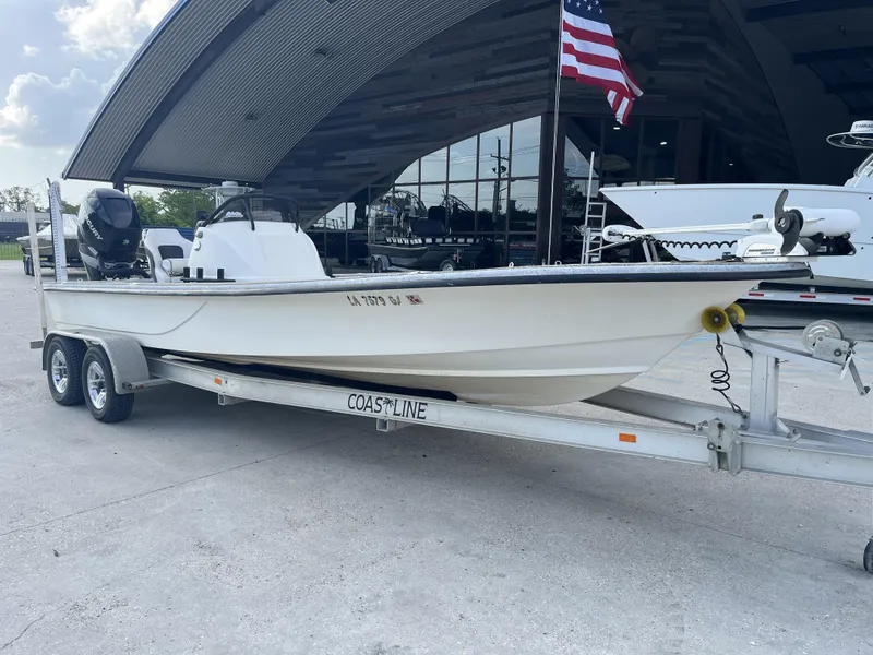 Slide: The Image of 2013 Haynie 24 HO boat on trailer, parked outdoors with American flag. - 8
