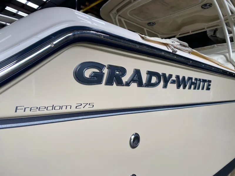 Slide: The Image of 2021 Grady-White Freedom 275 boat, close-up of logo and model name. - 10