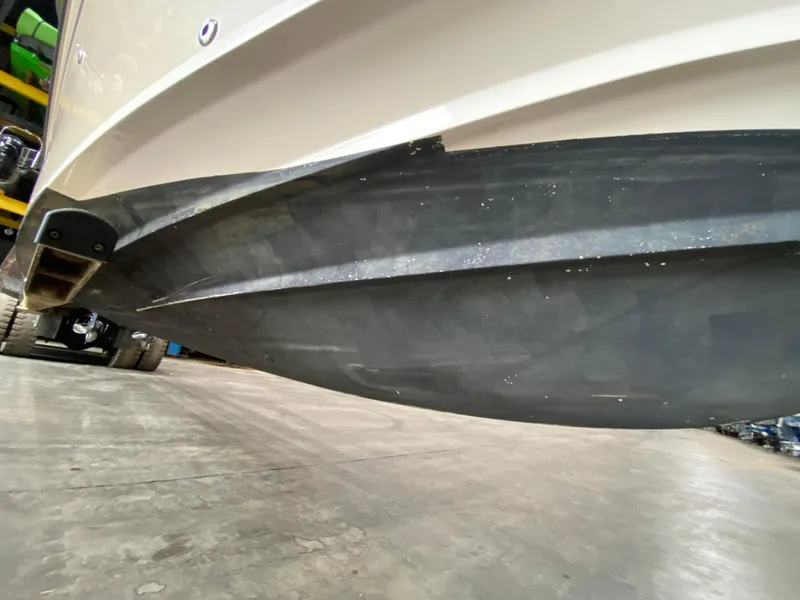 Slide: The Image of 2021 Grady-White Freedom 275 boat hull on a trailer in a garage. - 12