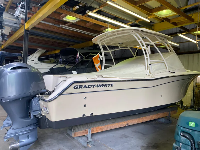 Slide: The Image of 2021 Grady-White Freedom 275 boat in storage, featuring dual engines and sleek design. - 14