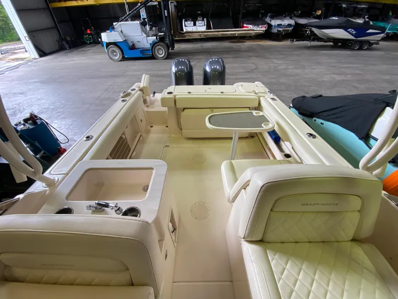 Slide: The Image of 2021 Grady-White Freedom 275 boat interior with seating and table in a storage facility. - 15