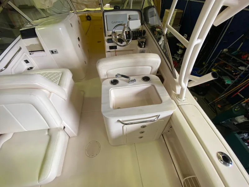 Slide: The Image of 2021 Grady-White Freedom 275 boat interior with steering wheel and sink area. - 17