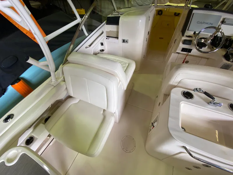 Slide: The Image of 2021 Grady-White Freedom 275 boat interior with seating and Garmin navigation system. - 18