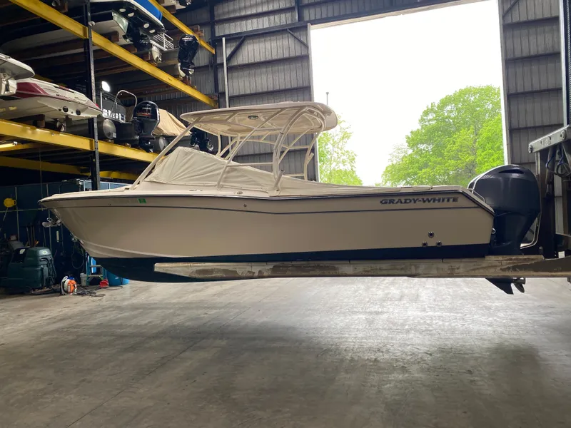 Slide: The Image of 2021 Grady-White Freedom 275 boat in storage, side view, indoors. - 2
