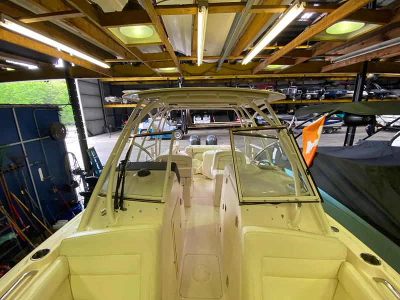 Slide: The Image of 2021 Grady-White Freedom 275 boat in a storage facility, showcasing its spacious interior and sleek design. - 26