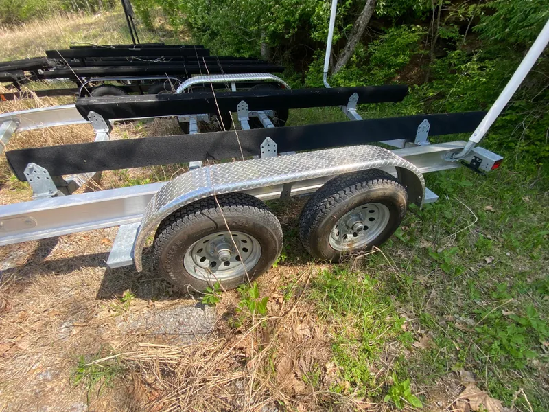 Slide: The Image of Trailer for 2021 Grady-White Freedom 275 boat, parked on grass. - 37