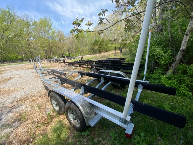 Slide: The Image of Trailer for 2021 Grady-White Freedom 275 boat in a wooded area. - 38
