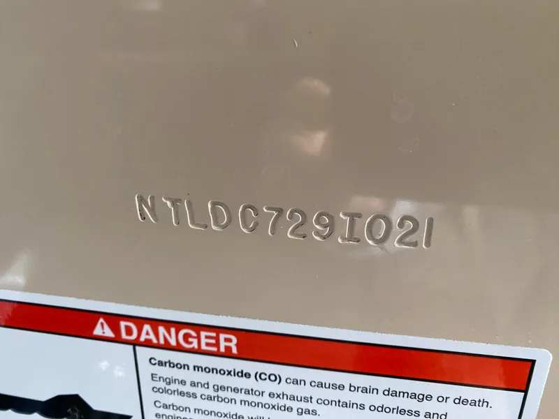 Slide: The Image of 2021 Grady-White Freedom 275 hull identification number with carbon monoxide warning label. - 40