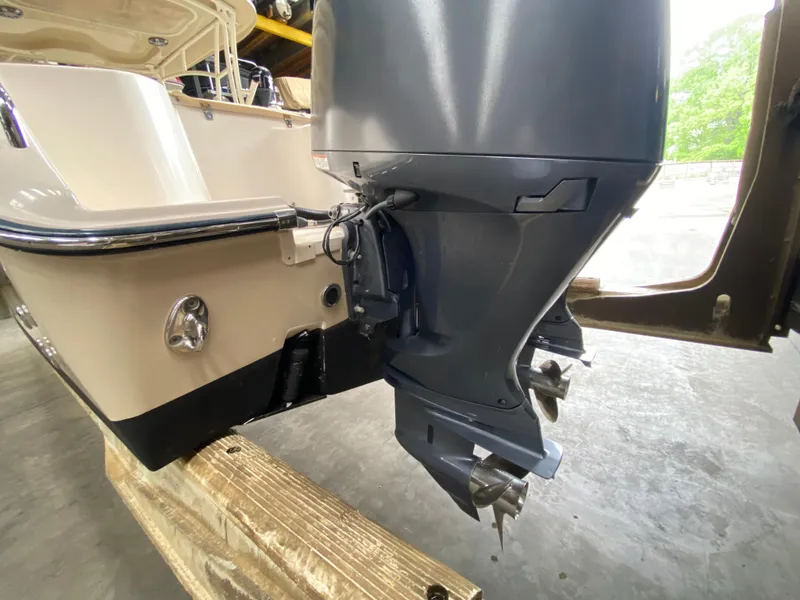 Slide: The Image of 2021 Grady-White Freedom 275 boat with outboard motor in a storage area. - 5