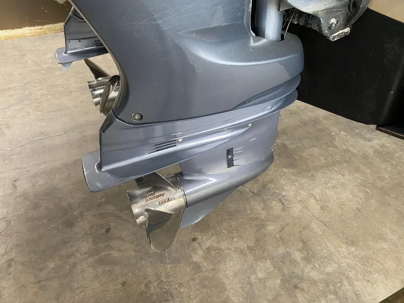 Slide: The Image of 2021 Grady-White Freedom 275 boat engine close-up with propeller on concrete floor. - 7