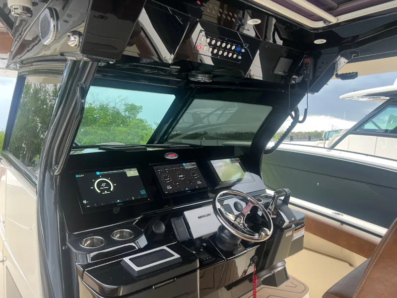 Slide: The Image of 2024 Scout 377 LXF boat cockpit with advanced navigation and control systems. - 13
