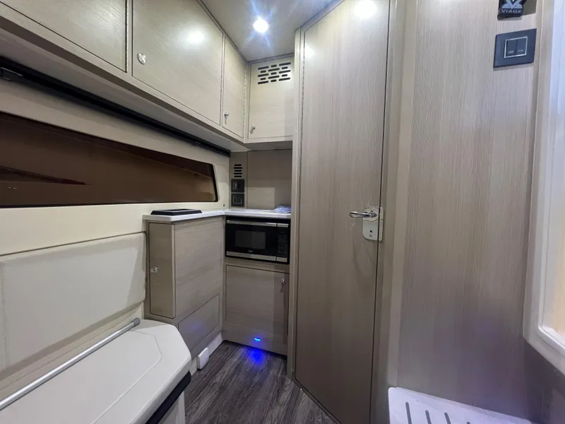 Slide: The Image of 2024 Scout 377 LXF interior with modern cabinetry and compact kitchen amenities. - 16