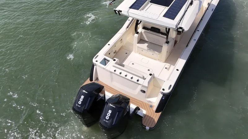 Slide: The Image of 2024 Scout 377 LXF boat with dual engines on water. - 20