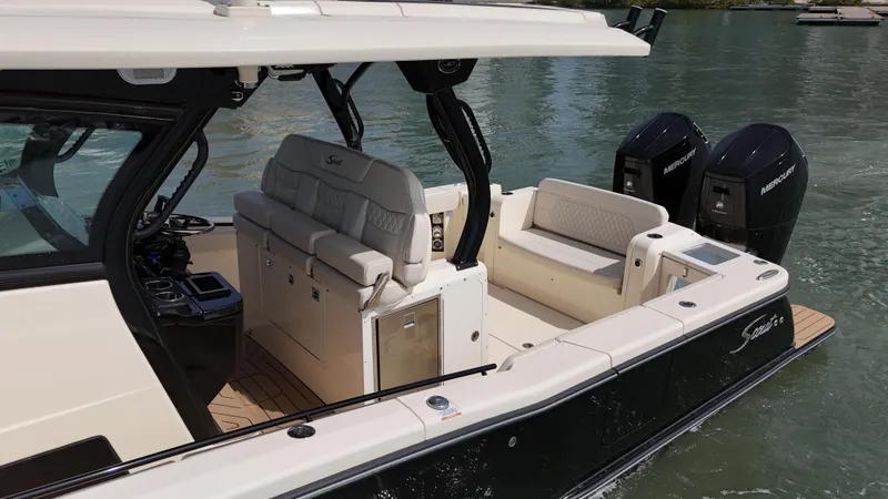 Slide: The Image of 2024 Scout 377 LXF luxury boat with spacious seating and dual outboard engines. - 21
